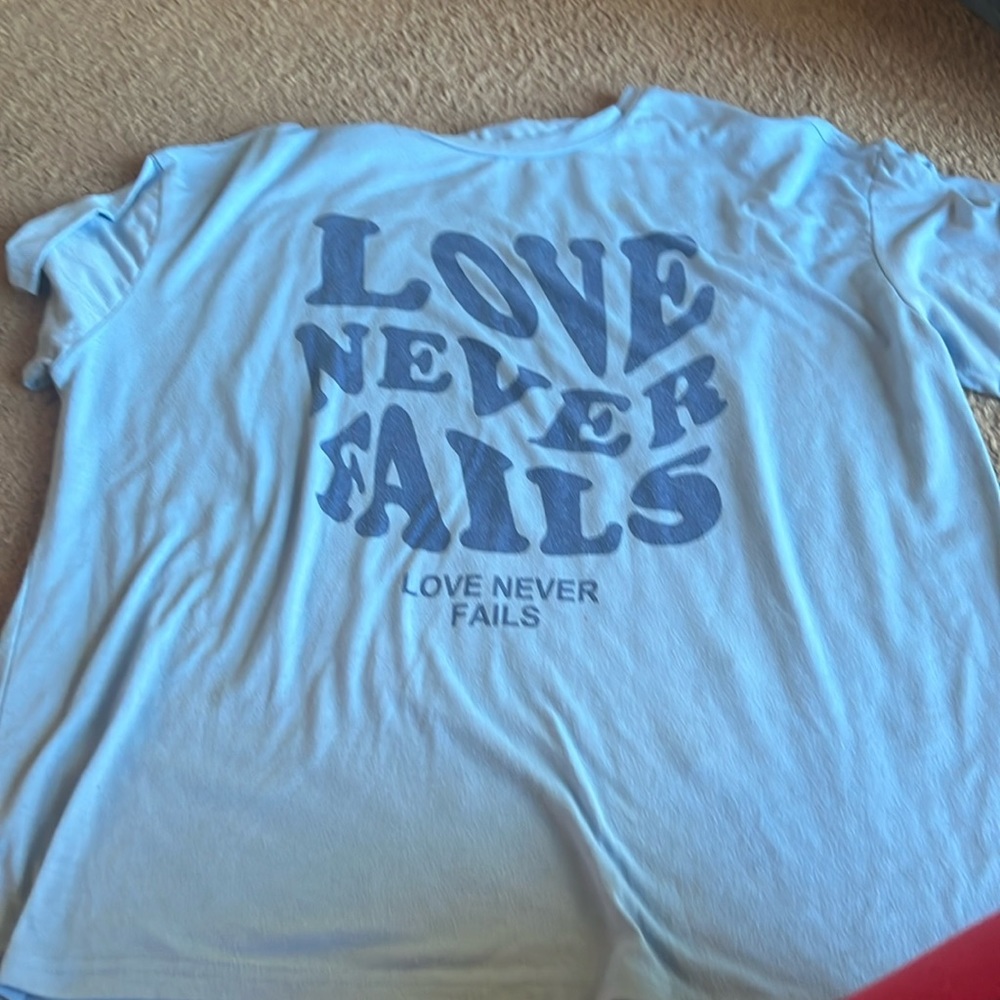Love never fails slogan t-shirt
